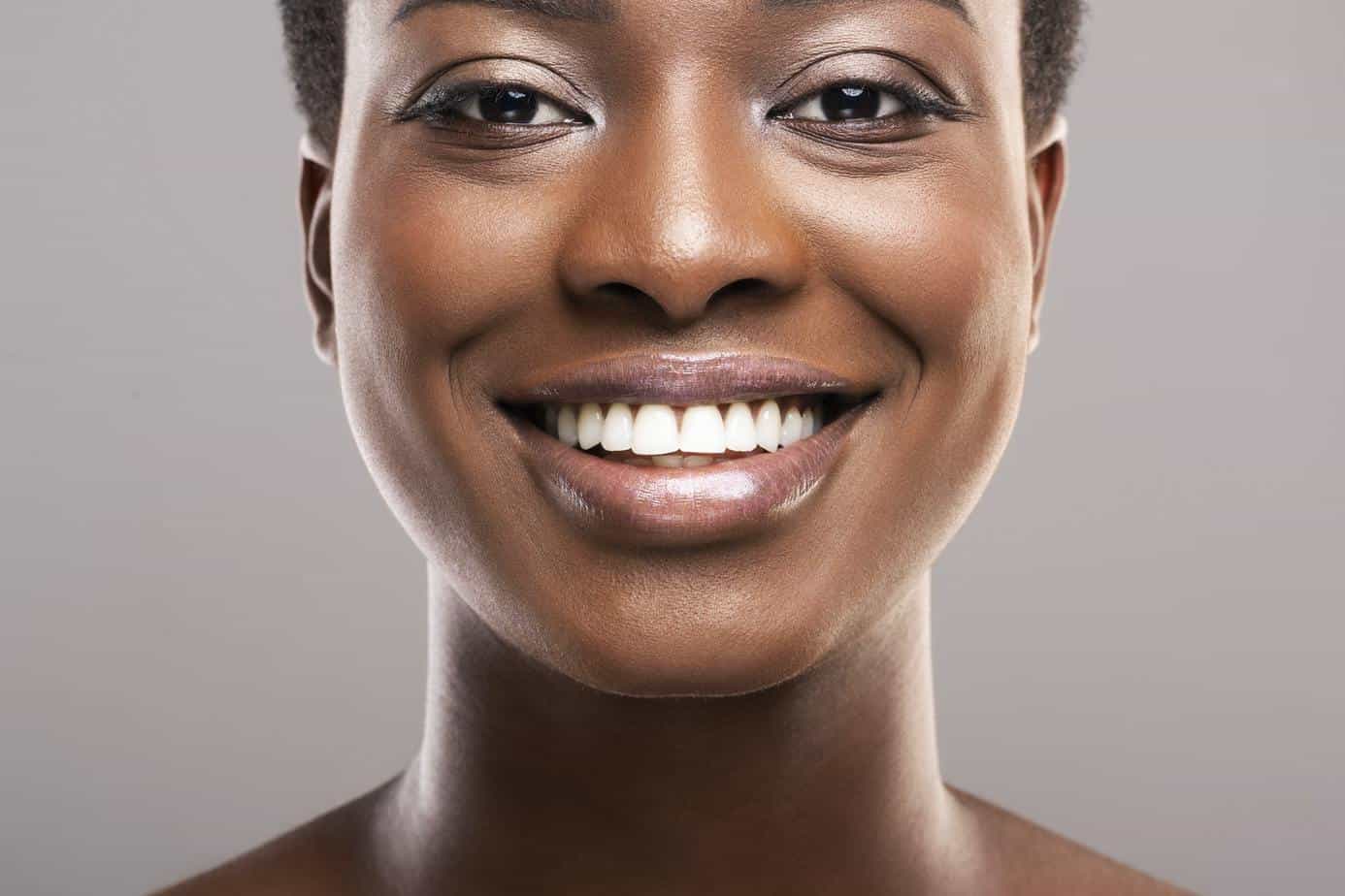 Portrait of black woman with perfect skin and white teeth