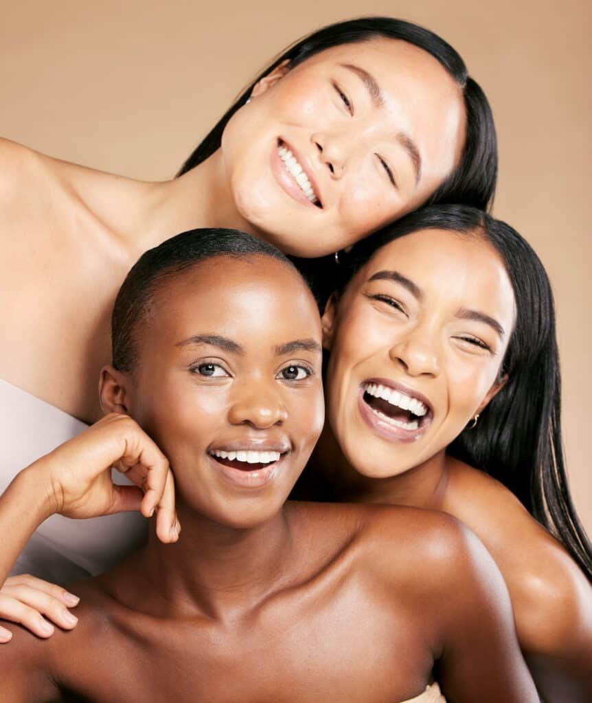 Friends, diversity and skincare, women smile together in happy portrait on studio background. Healt